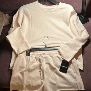 2 piece set in blush by DKNY. Drawstring shorts with a cropped long sleeve top.